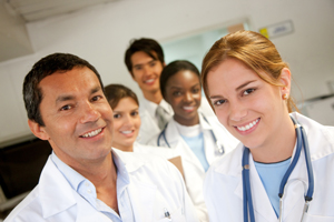 This is a picture of a group of medical professionals smiling for the picture.